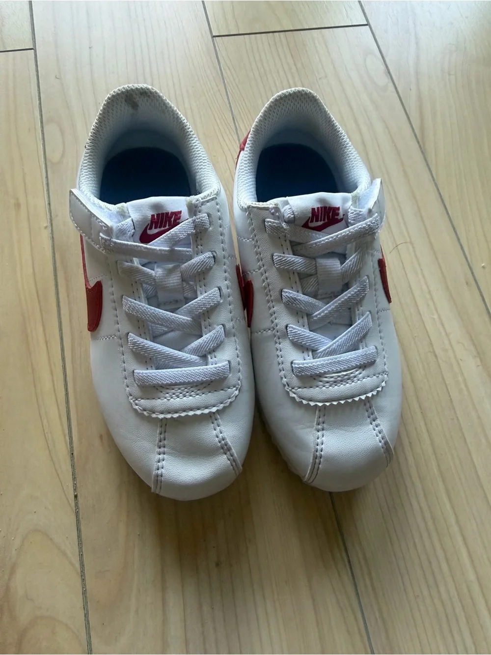 Nike Kids White Sneakers with Red Swoosh